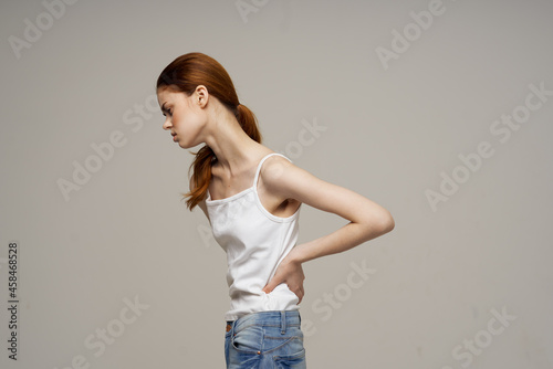 woman in white t-shirt pain symptoms in the joints arthritis studio treatment