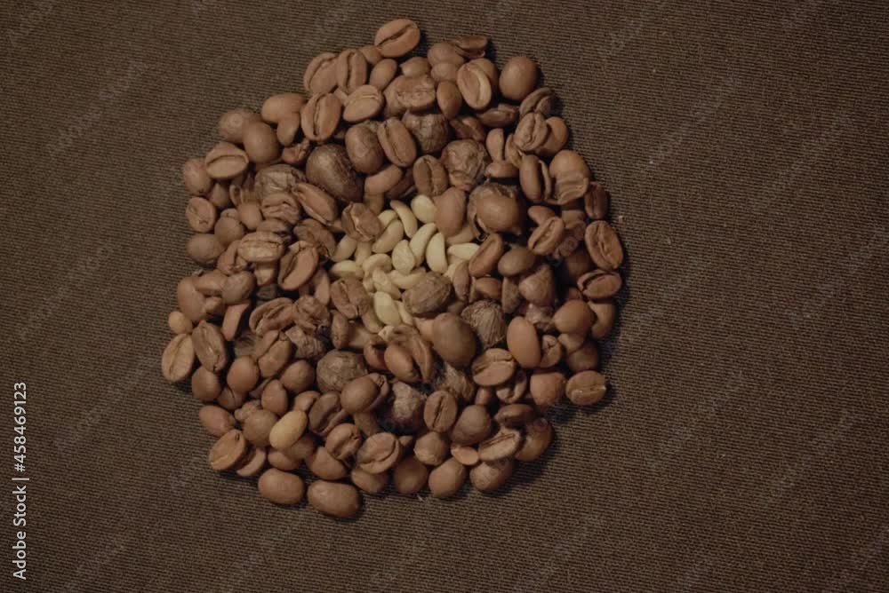 Stop motion of coffee beans showing the process from roasting to grinding by making figures on a table. Animated video Stop motion of coffee beans showing the process from roasting to grinding by making figures on a table. Animated video