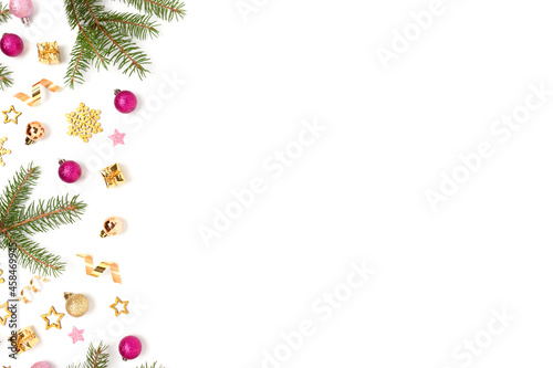 Border frame made of Christmas toys and fir tree branches on a white background. Festive composition with copy space.