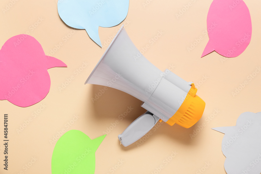 Fototapeta premium Modern megaphone and speech bubbles on color background