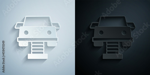 Paper cut Swing car on the playground icon isolated on grey and black background. Childrens carousel with car. Amusement icon. Paper art style. Vector