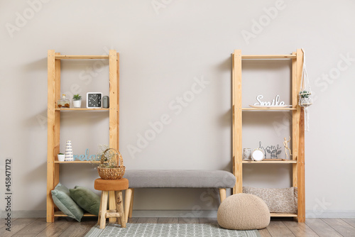 Modern TV stand with shelves and decor near light wall