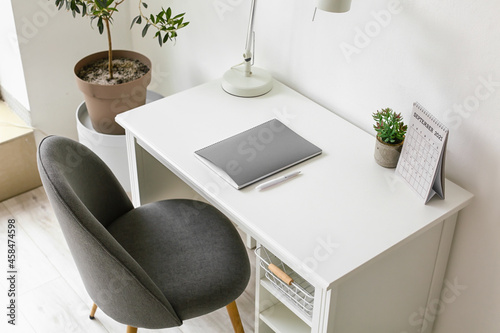 Modern workplace with lamp,...
