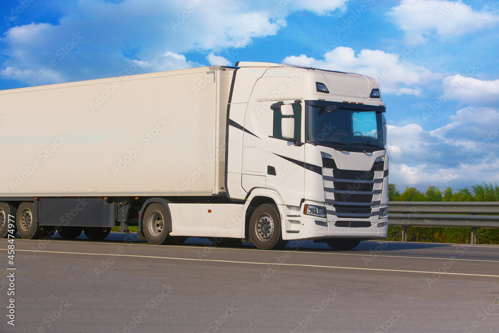 White truck driving on a suburban highway White truck driving on a suburban highway