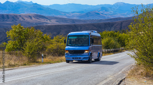 bus moves along the road in the mountains © Yuri Bizgaimer