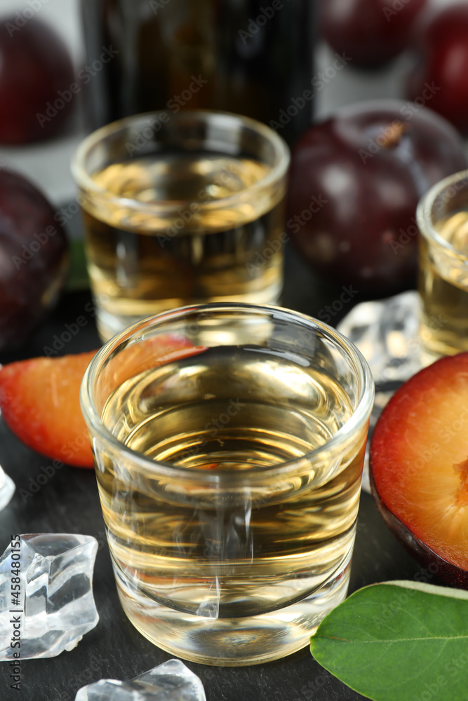 Concept of alcohol with plum vodka, close up Concept of alcohol with plum vodka, close up