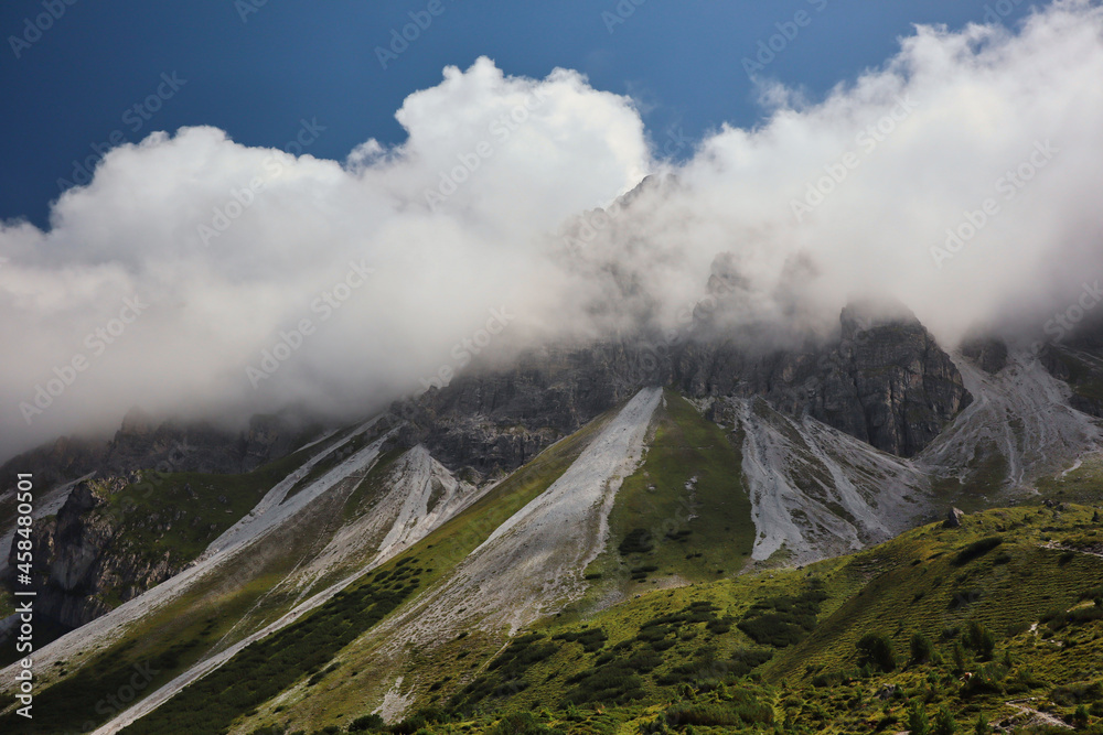 Dramatic Scene of High Rock in Clouds in Tyrol. Kalkkoegel Mountain Chain in Austria.
