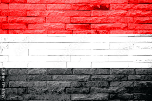 Yemen Flag on a brick wall background