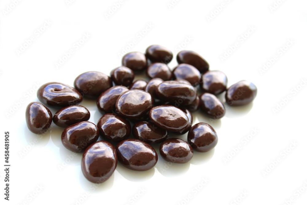 Dark chocolate covered nuts on white background Dark chocolate covered nuts on white background