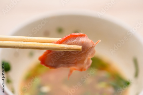 Pork chopsticks close up behind the bowl