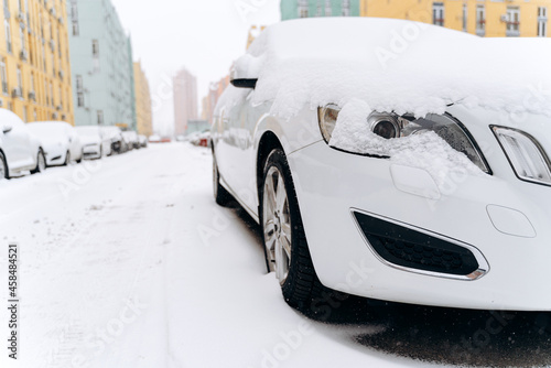 Winter road in the morning. Low angle view of the parked cars covered with snow at the street. Snow storm concept. Stock photo © speed300