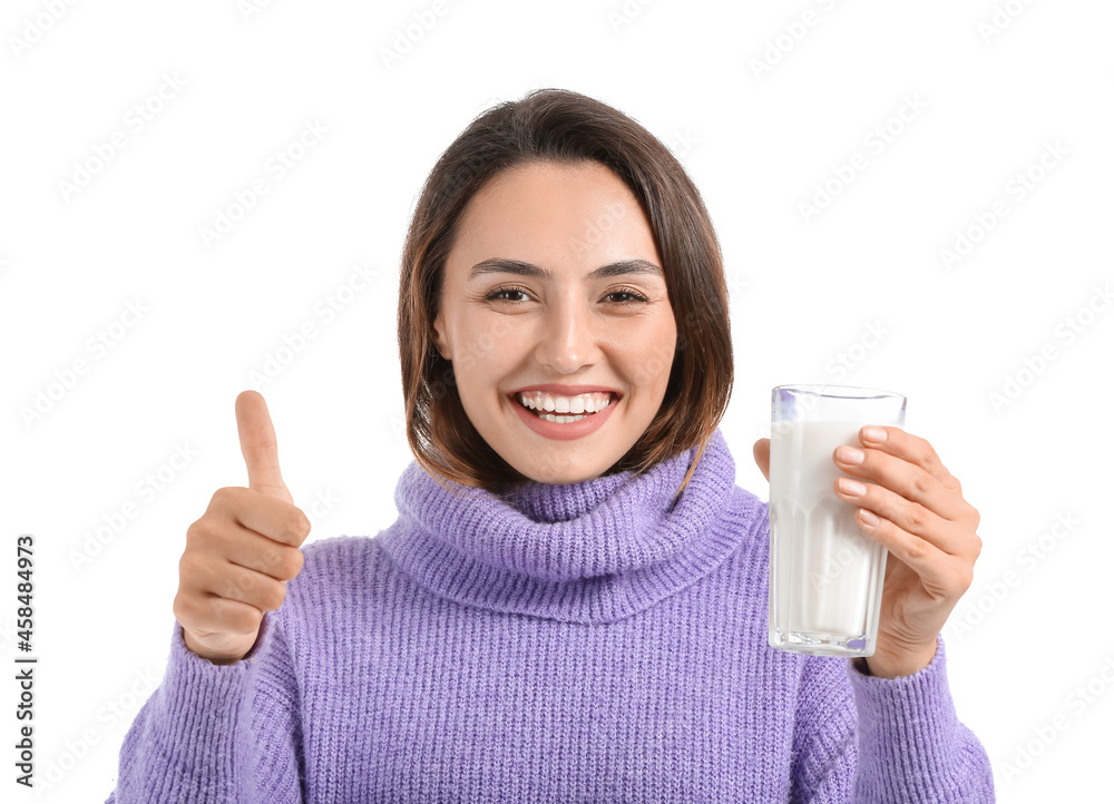 Young woman with glass of fresh milk showing thumb-up on white background Young woman with glass of fresh milk showing thumb-up on white background
