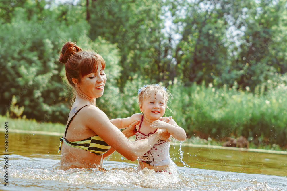 mother and daughter bathe in the river mother and daughter bathe in the river