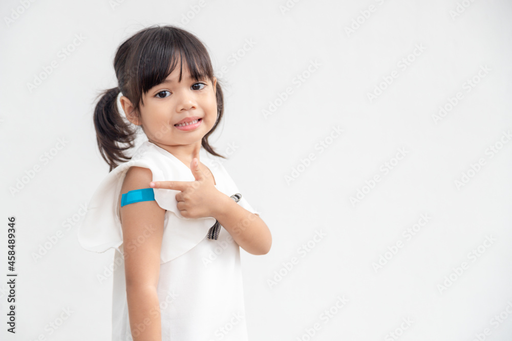 Asian little girl showing his arm after got vaccinated or inoculation, child immunization, covid delta vaccine concept Asian little girl showing his arm after got vaccinated or inoculation, child immunization, covid delta vaccine concept