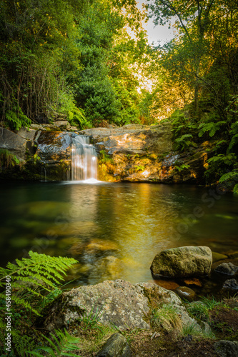 Beautiful water stream in Po  o da Cilha waterfall  Manhouce  Sao Pedro do Sul  Portugal. Long exposure smooth effect. Mountain forest landscape.