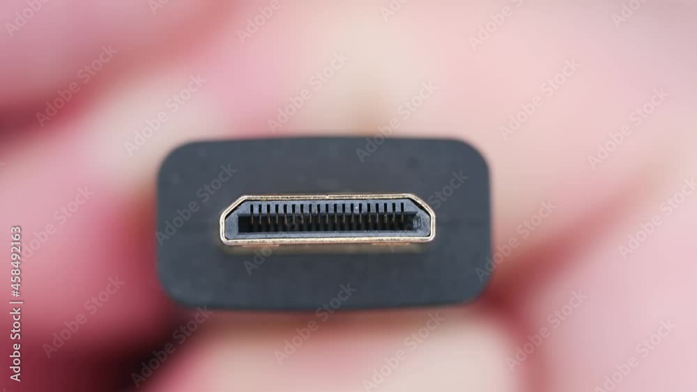 Close up of HDMI display monitor connector system or connection interface in hand isolated on white background. Display transfer information for digital camera gadget smartphone or laptop. Close up of HDMI display monitor connector system or connection interface in hand isolated on white background. Display transfer information for digital camera gadget smartphone or laptop.