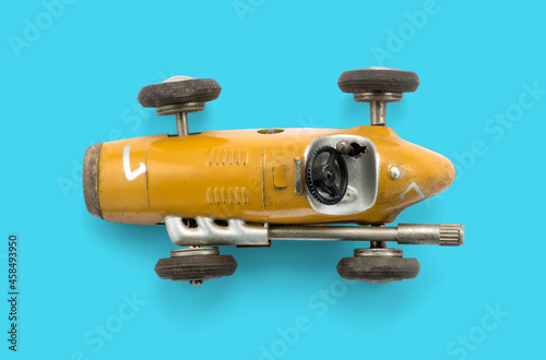 Model of retro racing car on cyan background