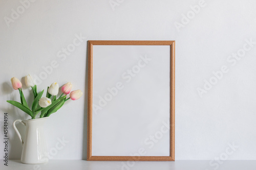 A brown blank frame with tulip over the white background. 