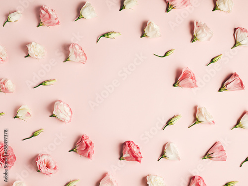 Fototapeta Naklejka Na Ścianę i Meble -  Pink, white, and pastel rose flower and buds creating a circular frame on a pastel pink background. Creative floral concept. Romantic arrangement of blooming spring flowers with copy space. Flat lay.