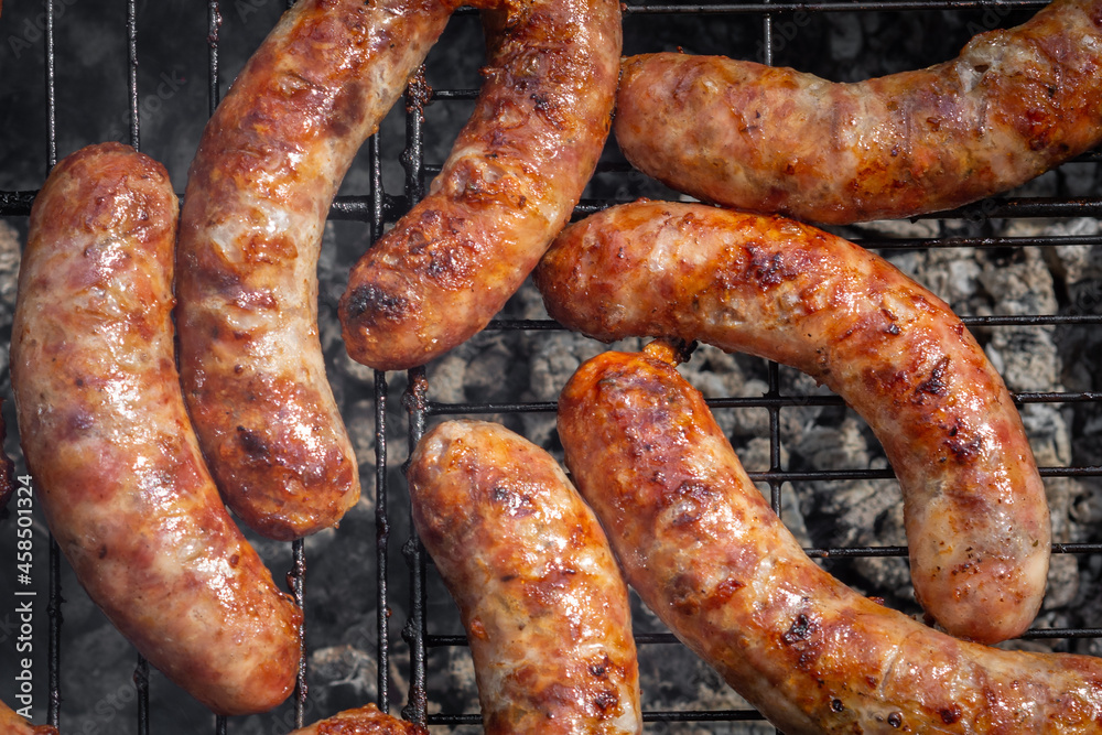homemade pork sausages are grilled in the open air. view from above. street food homemade pork sausages are grilled in the open air. view from above. street food