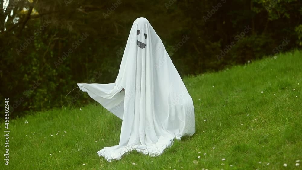 child dressed up as ghost for halloween, kid costume of a ghost, outdoor shoot, natural background. child dressed up as ghost for halloween, kid costume of a ghost, outdoor shoot, natural background.