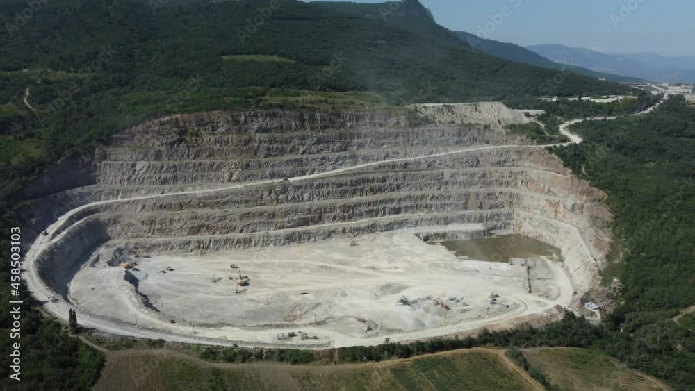 Aerial view industrial of opencast mining quarry with lots of machinery ...