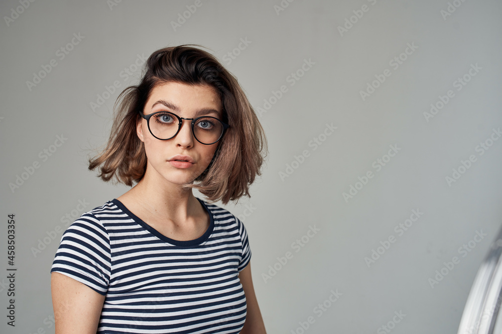 beautiful woman in a striped T-shirt light background Lifestyle beautiful woman in a striped T-shirt light background Lifestyle