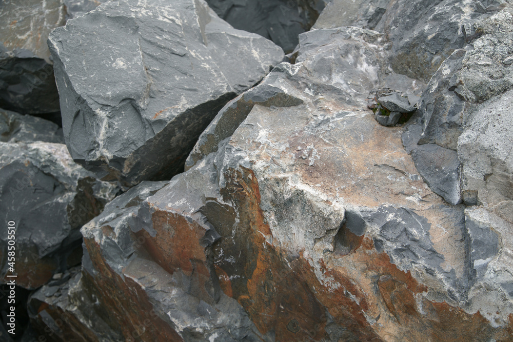 Basalt. Fancy patterns on the rocks. The texture of the stone. Severoonezhsky basalt mine. Arkhangelsk region, Russia.