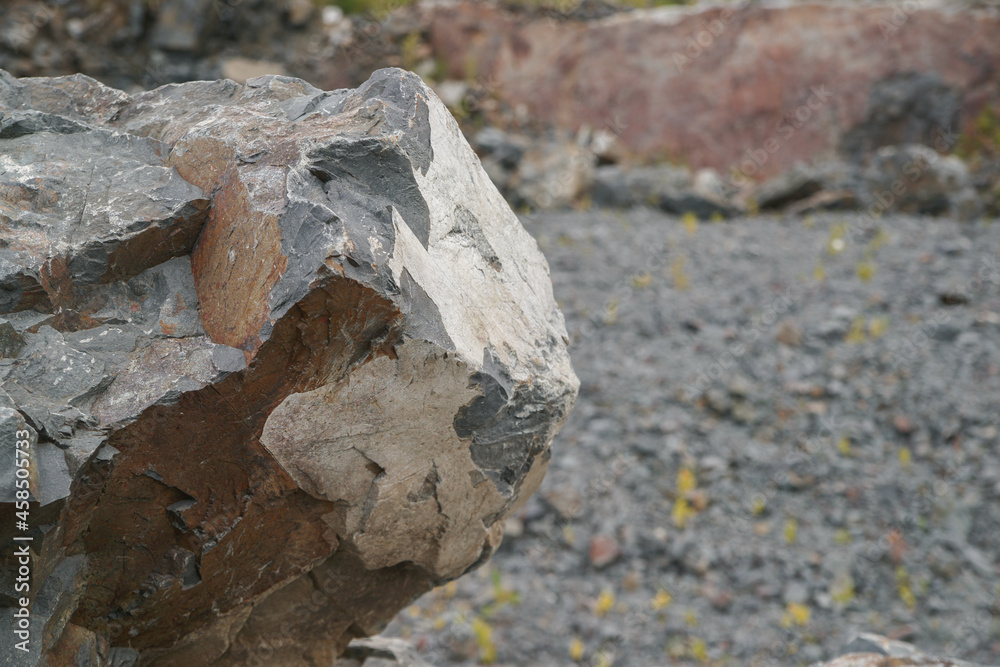 Basalt. Fancy patterns on the rocks. The texture of the stone. Severoonezhsky basalt mine. Arkhangelsk region, Russia.