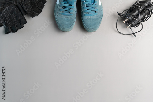 Healthy lifestyle. Jump rope equipment on a grey background. Top view with copy space.