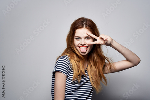 beautiful woman in a striped t-shirt gesture with his hands isolated background