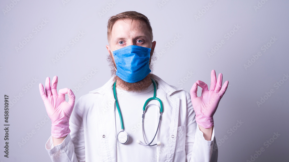 Male doctor in laboratory coat on gray background Male doctor in laboratory coat on gray background