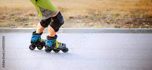 Roller skates. Inline skating on asphalt road in nature