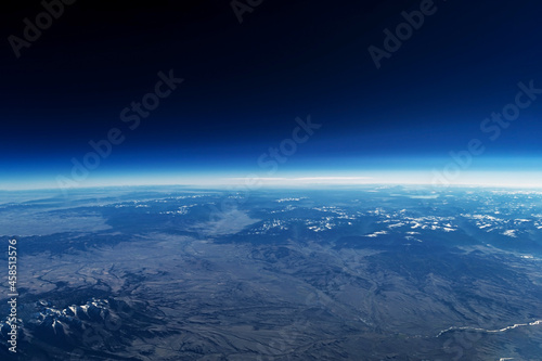 Earth's atmosphere from space, on a dark background. Elements of this image were furnished by NASA.