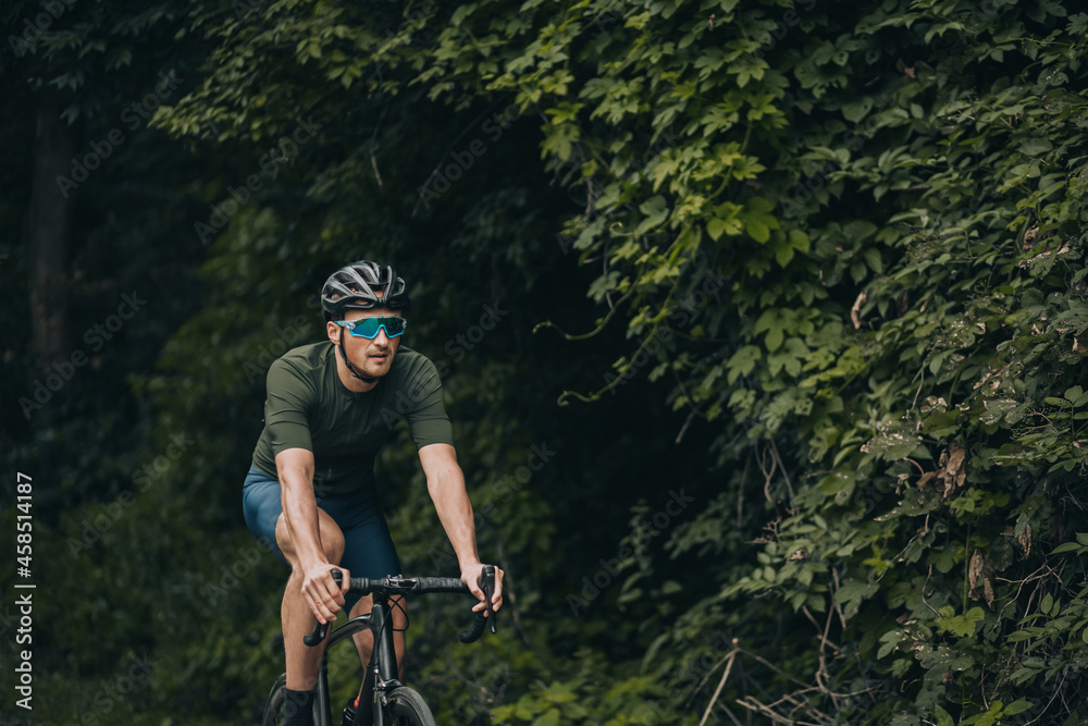 Man in helmet and glasses practising in cycling at park Man in helmet and glasses practising in cycling at park