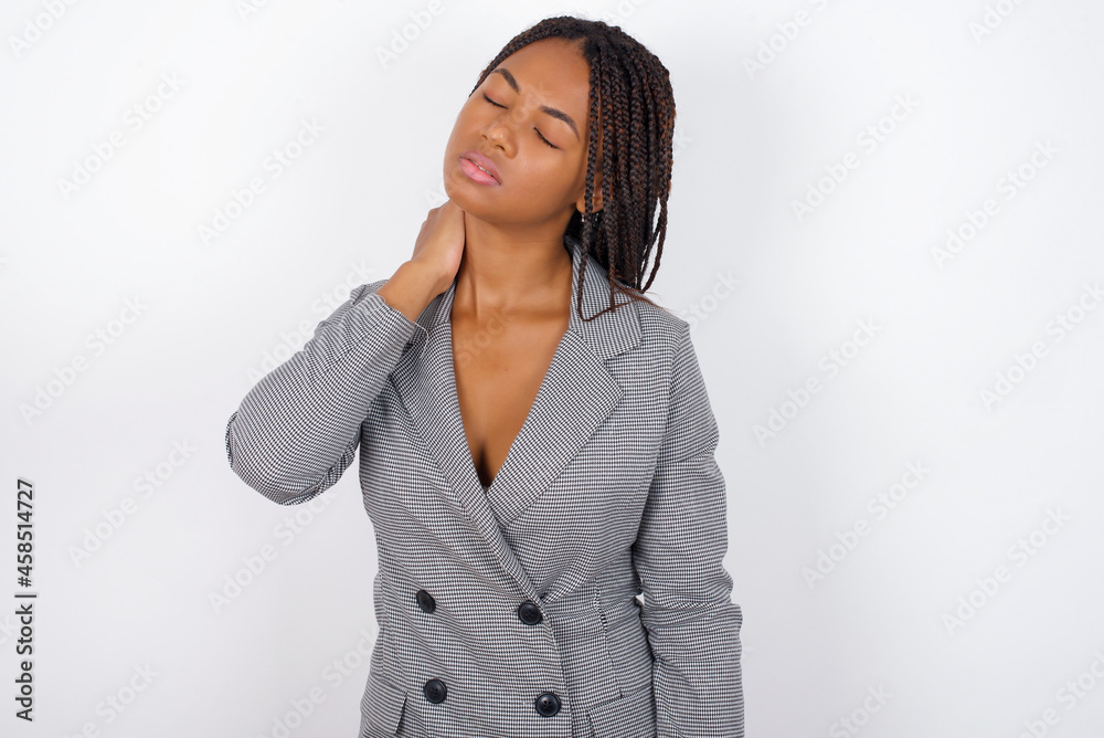 MODEL suffering from back and neck ache injury, touching neck with hand