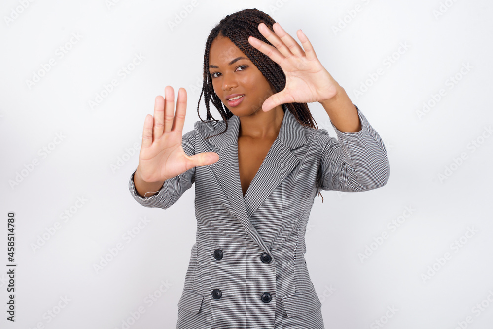 Portrait of smiling MODEL looking at camera and gesturing finger frame. Creativity and photography concept. Portrait of smiling MODEL looking at camera and gesturing finger frame. Creativity and photography concept.