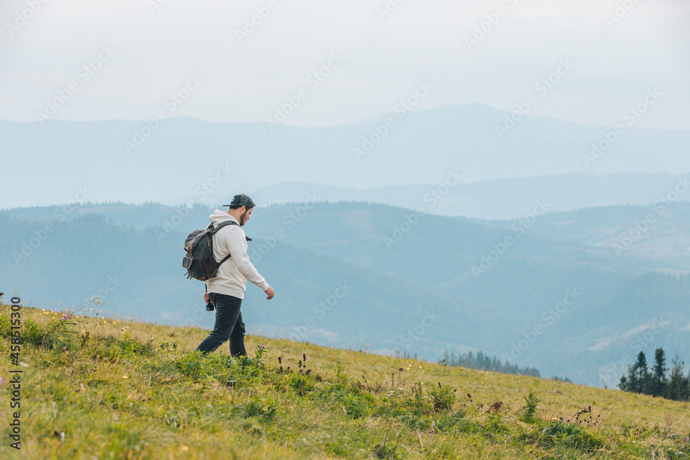 man with backpack hiking in mountains man with backpack hiking in mountains