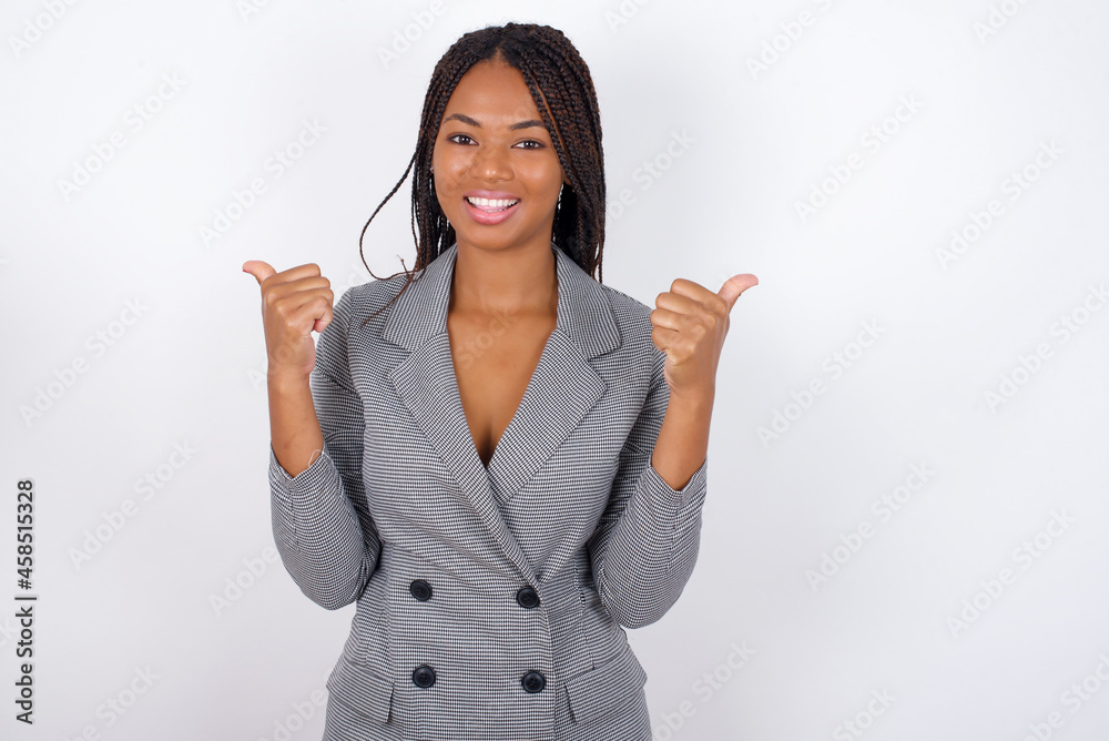 Optimistic MODEL showing thumbs up with positive emotions. Quality and recommendation concept. Optimistic MODEL showing thumbs up with positive emotions. Quality and recommendation concept.