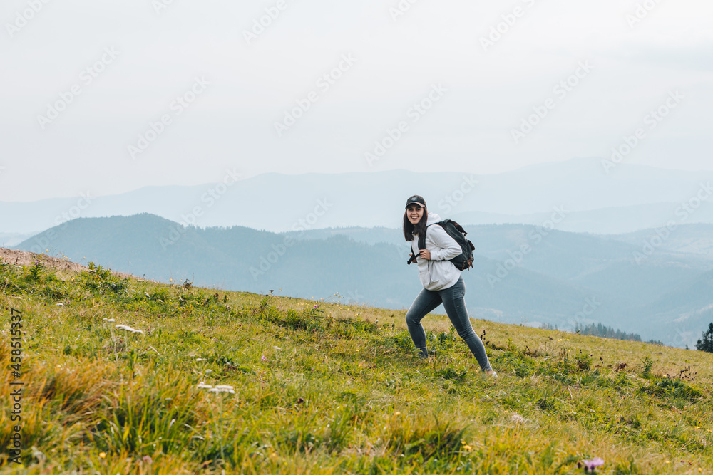 woman with backpack hiking in mountains woman with backpack hiking in mountains