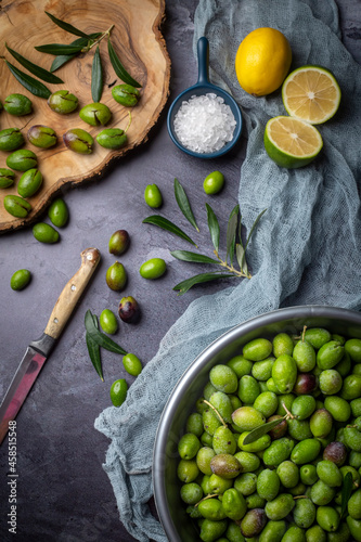 Homemade crushing olive making. Fresh green olives are breaking one by one. Crushing olives with stone. Preparing pickled olives in Turkish style. (Turkish name; kirma zeytin) photo