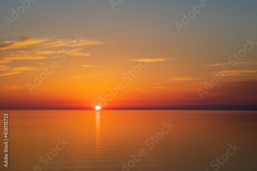Sun going down at sunset over a calm sea © welshpix