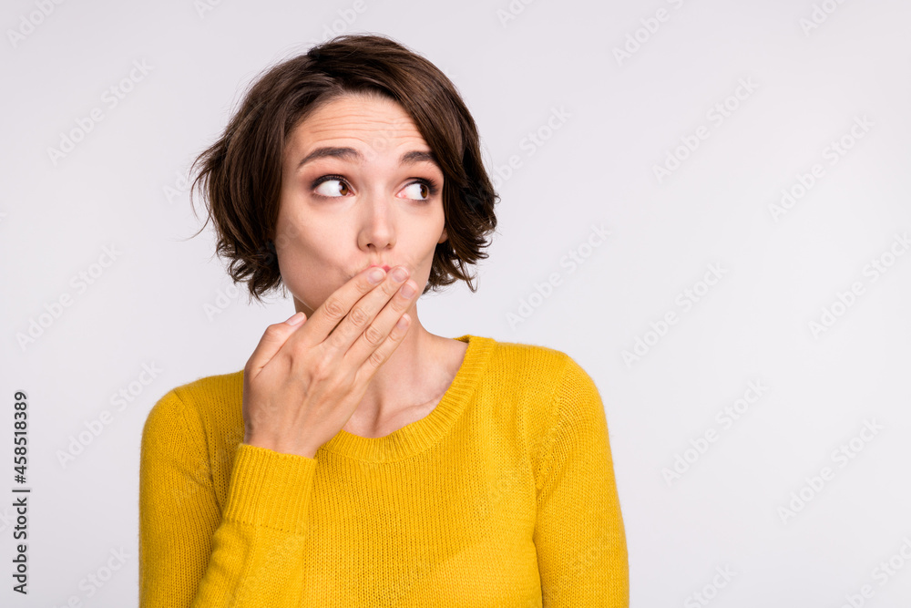 Photo of speechless funky girl hand cover mouth look empty space wear yellow shirt isolated grey color background Photo of speechless funky girl hand cover mouth look empty space wear yellow shirt isolated grey color background