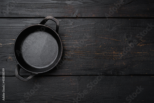 Empty cooking pot with copy space for text or food with copy space for text or food, top view flat lay , on black wooden table background