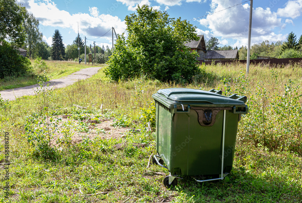 Green plastic garbage container at the outdoors Green plastic garbage container at the outdoors