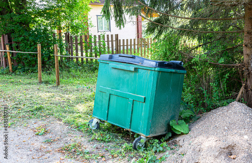 Green plastic garbage container at the outdoors