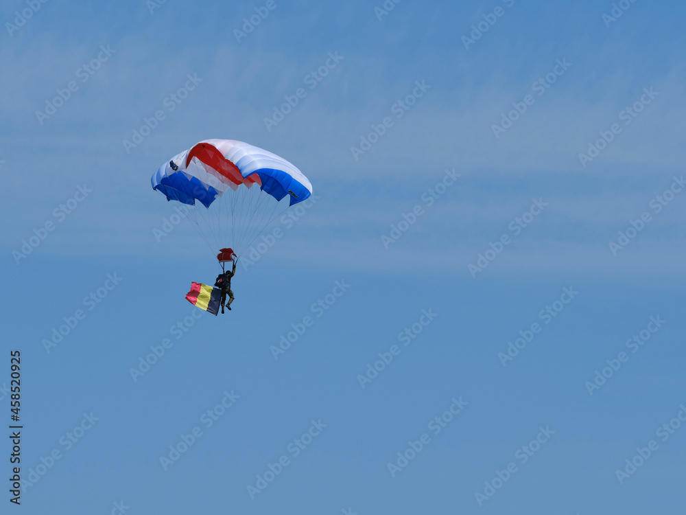 Parachutist and Belgium flag in flight Parachutist and Belgium flag in flight