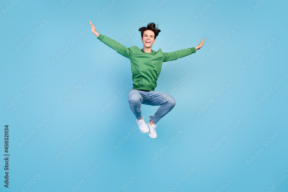 Full length body size photo guy jumping high careless laughing isolated pastel blue color background