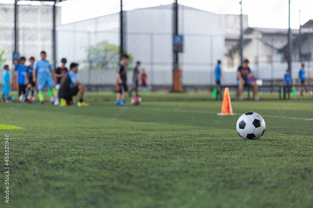 Soccer ball tactics cone on grass field with for training background