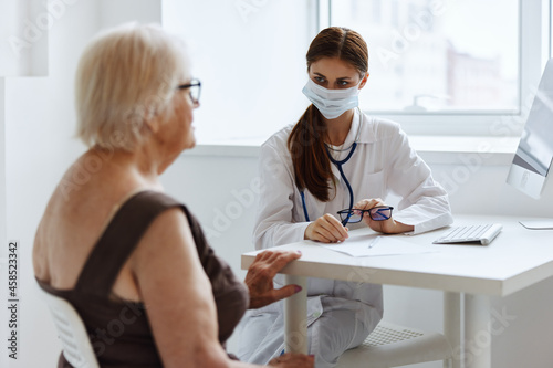 elderly woman patient communicates with the doctor health diagnostics